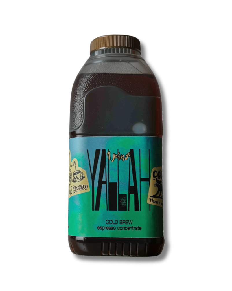 A bottle of Yallah Cold Brew coffee concentrate with a dark brown liquid inside, featuring a teal and black label with gold accents, on a white background.